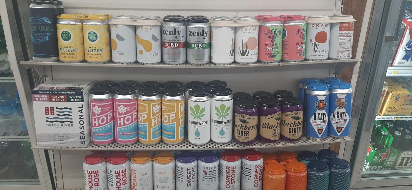 A shelf of craft beer cans at Shaw Market, arranged face out