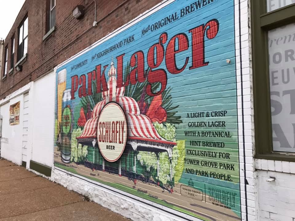 A painted Schlafly Park Lager mural on the side wall of the Shaw Market building